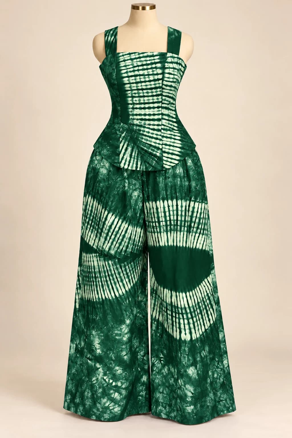 Concept product photograph of a green adire peplum top and wide-leg trousers